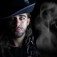 Pirate, captain, buccaneer, piercing grey eyes, long hair, hat with feather, scruff of beard, dark clothes and smokey background