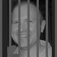 A photograph of me, where I have edited it to make it appear that I am behind prison bars.