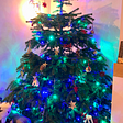 A Christmas tree with green and blue lights