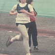 The author, running on a the track, competing in a race back in her younger days.