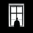 Man looking out of a window. Lots of negative space