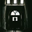 Silhouette of a person standing in a doorway