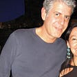 A candid photo of Anthony Bourdain in a navy blue t-shirt.