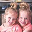 Photo of 2 smiling young girls.