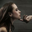 A dark-haired woman’s chin being held up by one finger- Picture from Depositphotos.com