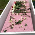 Pink casket for Eileen. Myself and another woman named Claudia placed white and an occasional red rose upon it.