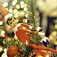 Elf on The Shelf close up holding onto Christmas tree