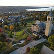 An Ariel picture of Cornell University in the bottom right of the foreground. Beyond Cornell University is downtown Ithaca and Cayuga lake in the upper right corner.