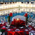 A table by a pool with roses for my article on 7 Habits of Hopelessly Romantic Partners