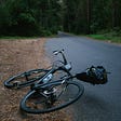 Bicycle on its side on a lonely isolated road.