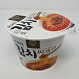 An unopened cup of YouUs Omori Kimchi Stew Ramen.