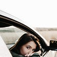 woman looks back in a car