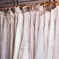 A row of wedding dresses on a rack
