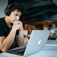 A man contemplates with headphones during a remote learning session. Online learning is harder than in-person learning — here’s how to cope.