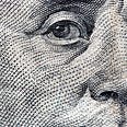 A closeup of Ben Franklin on a $100 bill.