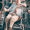 An elderly woman in a wheelchair