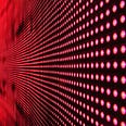 Close up shot of a wall of red LEDs that is curving into the distance