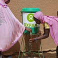 Halima and son at Oxfam handwashing station, Tondikwindi Treatment Center, Ouallum, Niger. Photo: Abbie Trayler-Smith/Oxfam