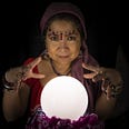 Fortune teller with a luminous crystal ball