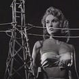 Allison Hayes in Attack of the 50 Foot Woman (1958) in a scene in which, wearing a bustier in the dark, she appears taller than an electricity pylon.