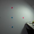 An image of my wall with 5 post-it notes creating a grid, 2 for x-axis, 2 for y-axis, and 1 in the middle