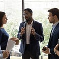 A man leading a meeting with diverse peers (Photo by fizkes on unsplash.com)