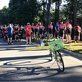 Crowd of cyclists at the dedication of a ghost bike for a person killed while riding his bike in Sandy Springs, Georgia