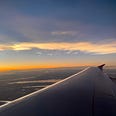 View from an airplane window during sunset