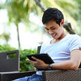 Man working from anywhere making money online and smiling about how easy it is