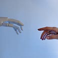 Robot hand reaching out to touch the pointer finger of a human hand