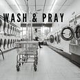 Black and white photo of a woman in a laundry mat.
