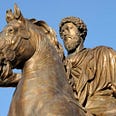 Pictured: A photograph of Marcus Aurelius as a statue, he is sitting on top of a horse, and has a characteristically stoic expression.