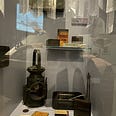 Chocolate tin box, lamp, cigarette box and lunch box displayed in the Bastogne war museum