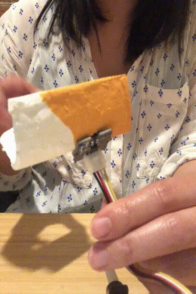 Gif of placing a roll of litter bags and an infrared sensor indicating proximity