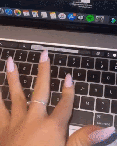 A gif of a woman’s hand typing quickly on a apple mac laptop keyboard