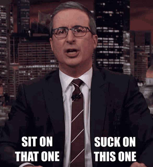 John Oliver holding up both middle fingers and saying “suck on this one, sit on that one”.