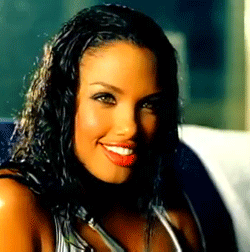 image of music video model from the early 2000s, light skin, light eyes and long wavy hair
