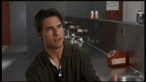 Actor Tom Cruise playing the character Jerry Maguire moving his hands toward chest then outwardly point hands saying “help me help you.”