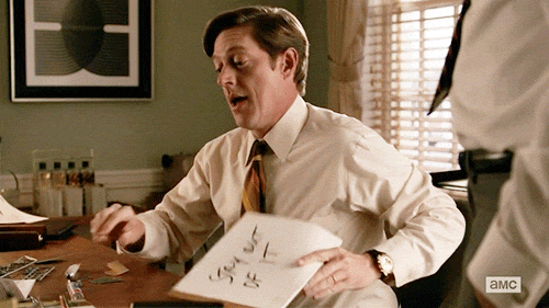 Mad Men character holding up a sign: Stay Out of It