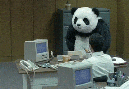 A panda throwing the stuff out of a desk and destroying a computer in front of a surprised group of people