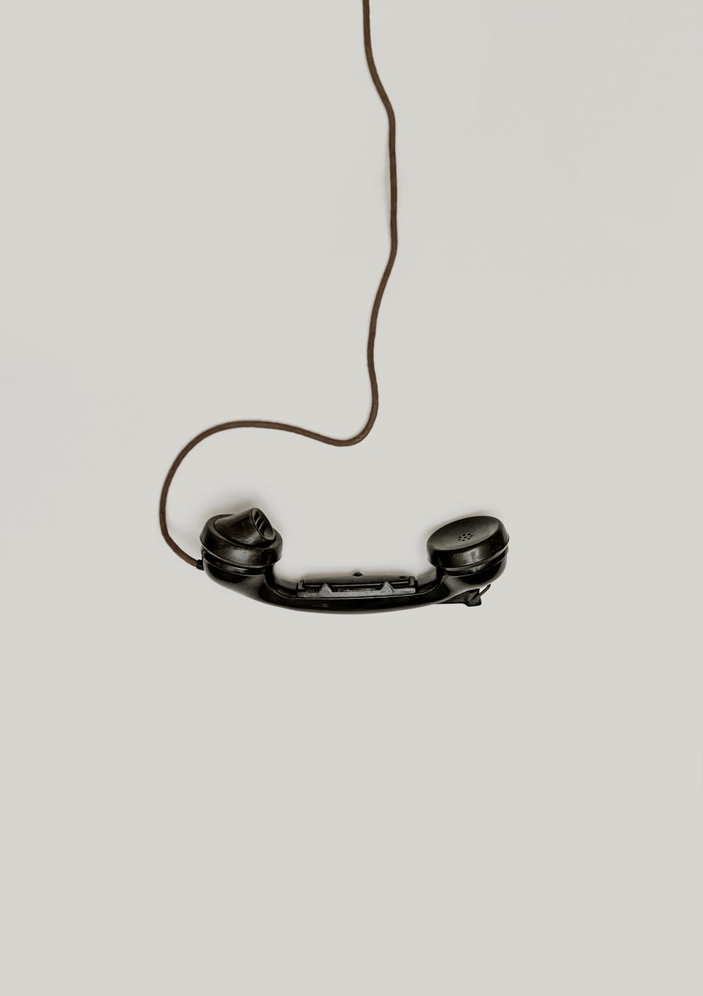 A black wired phone on a white background