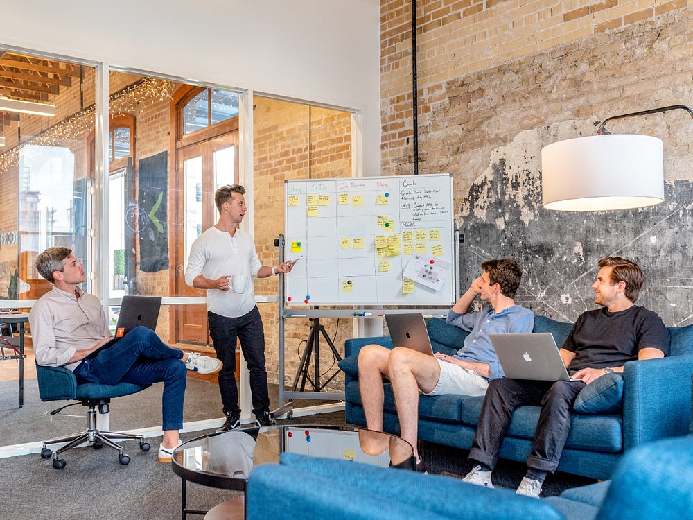 Brand executive taking whiteboard session with his team in the marketing department.