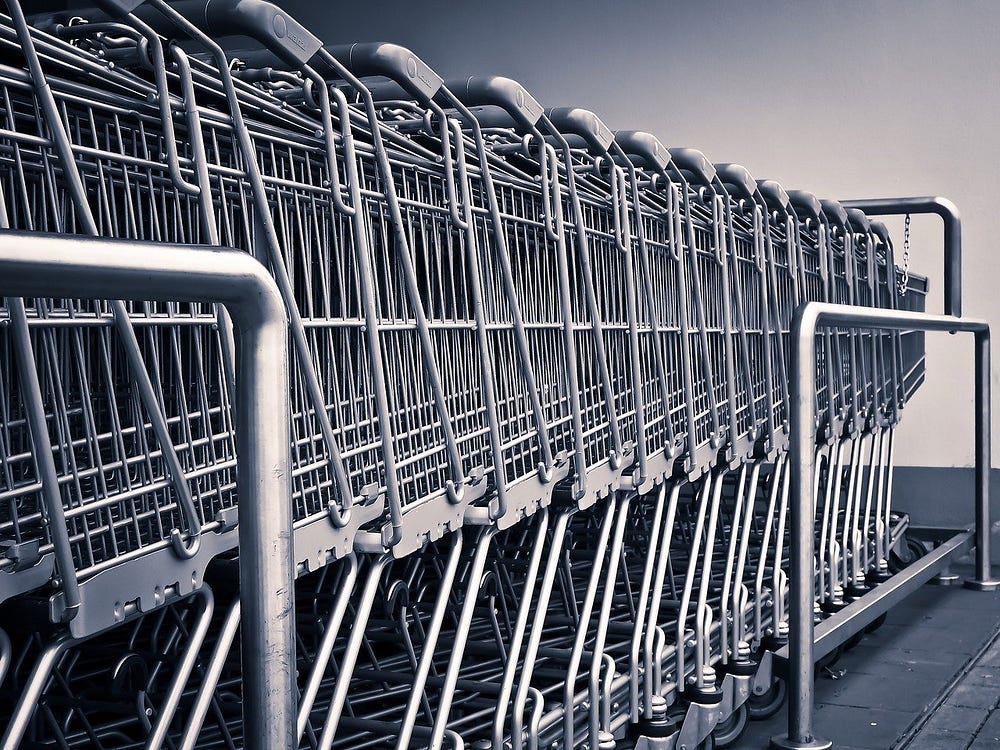 IMAGE: A line of empty shopping carts in a supermarket