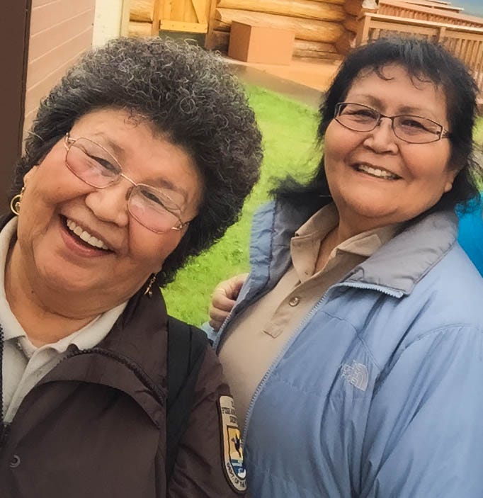 Photo of Cora Demit, Upper Tanana Athabascan, and Sylvia Pitka, Upper Tanana Athabascan, standing together.