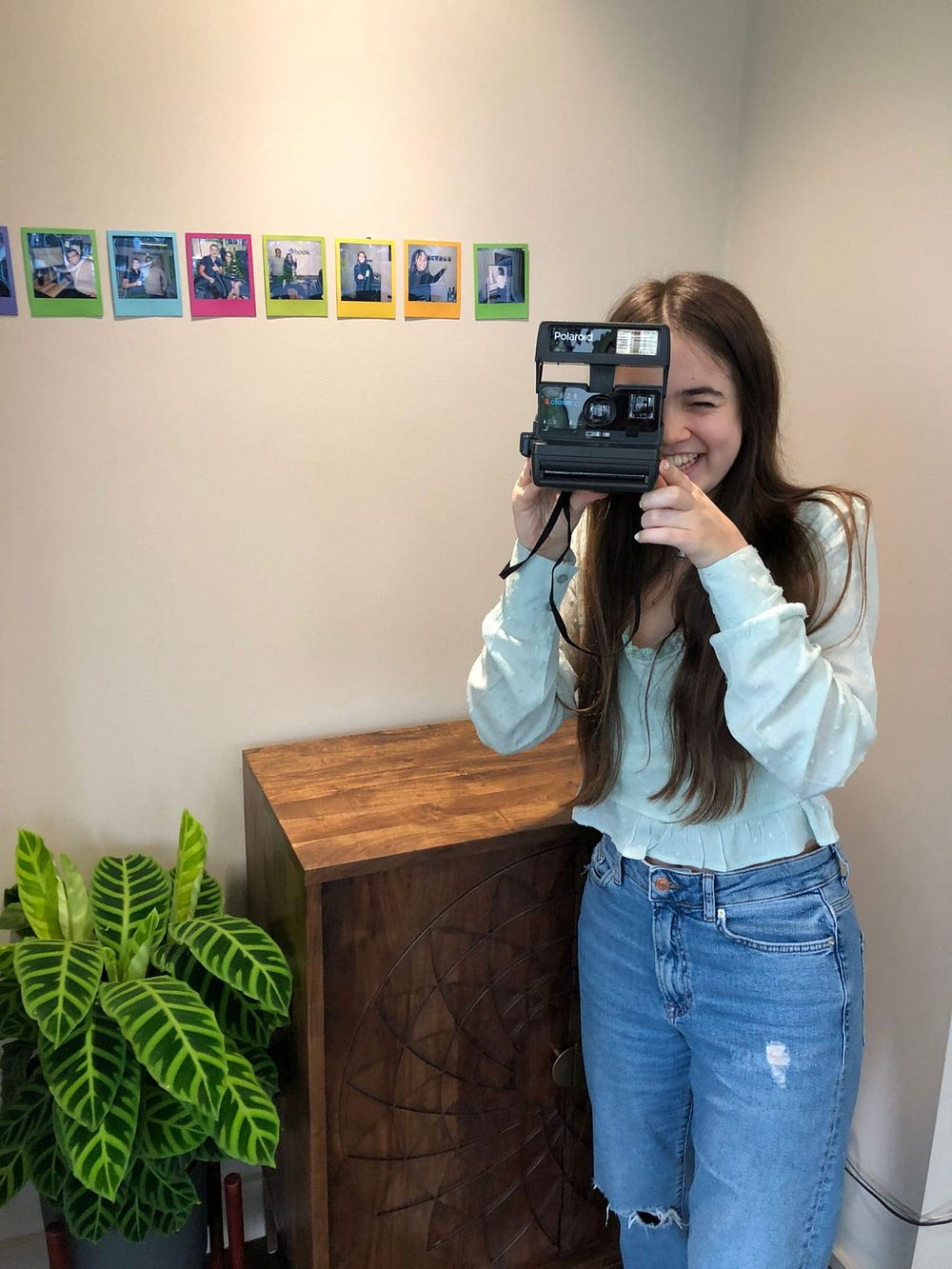 Merilin taking a photo with a polaroid