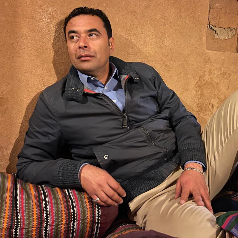 Wahid posing in a bomber jacket
