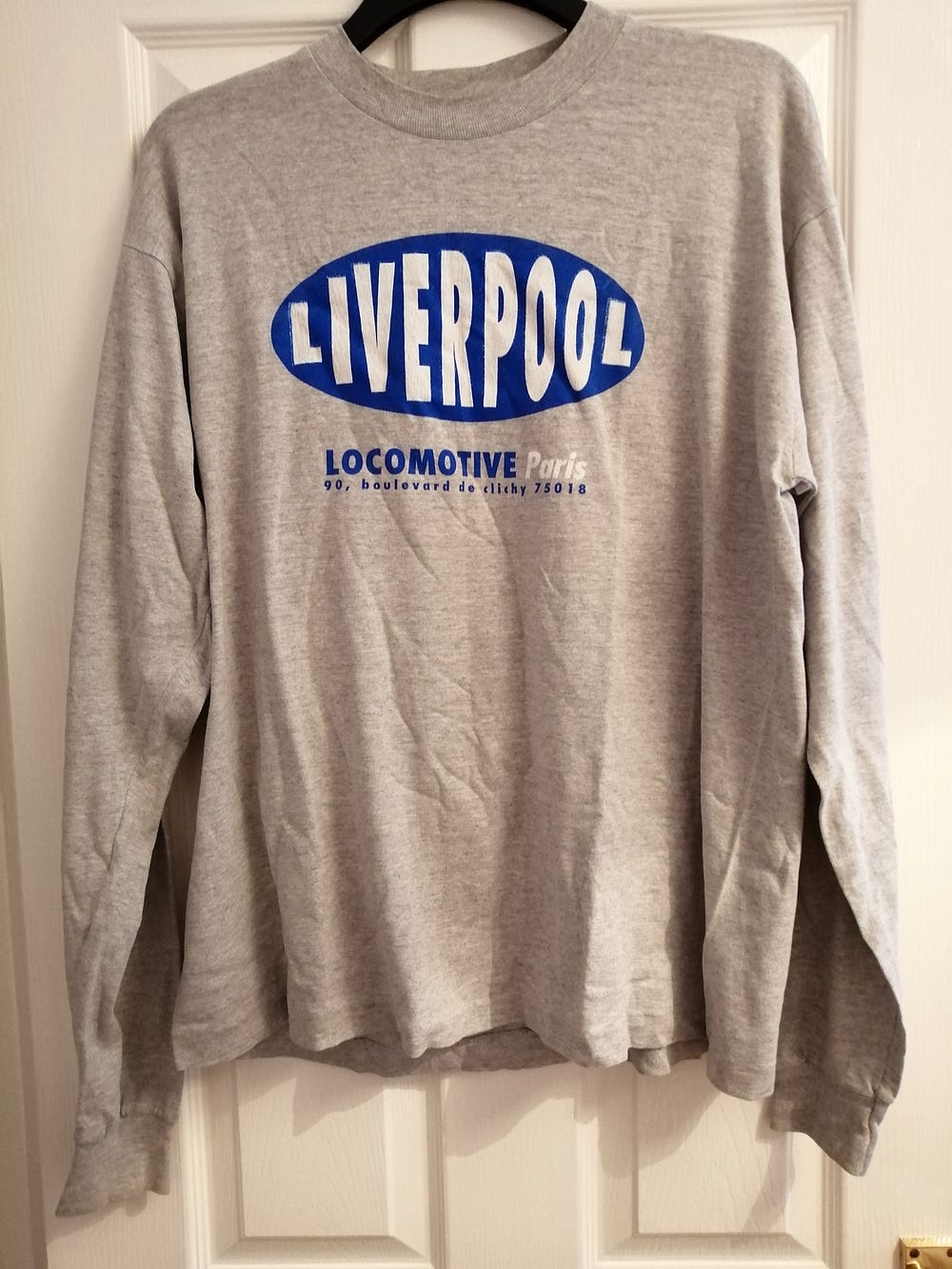 Liverpool in Paris long sleeved T shirt in grey with blue logo saying Liverpool on the front.