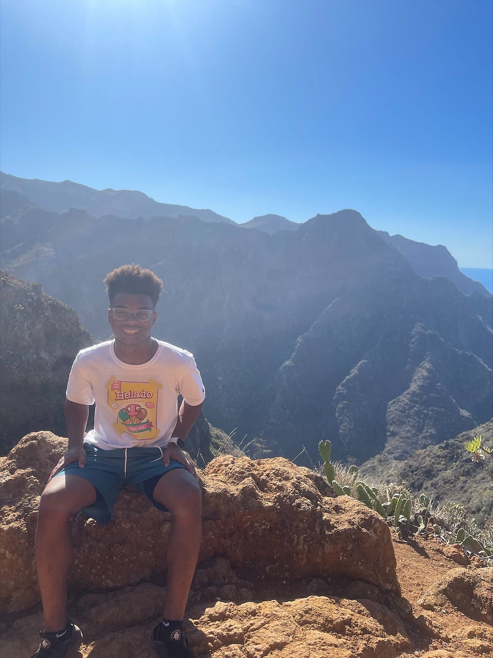 Andre’ smiles for a photo on a mountain