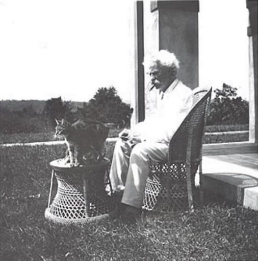 Mark Twain in his backyard with a cat.