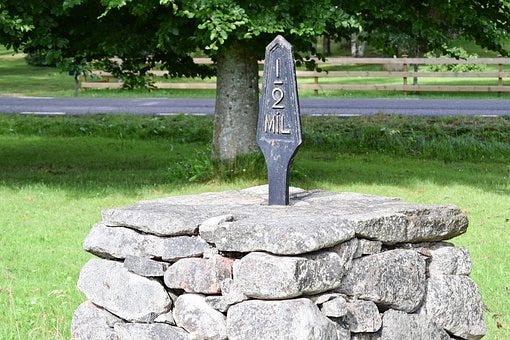 A milestone supported by a pile of stones